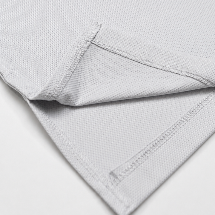TROS Resilience PDP 2026-05 · Polera Resilience - Gris · 06 · 06 hem/stitch detail
