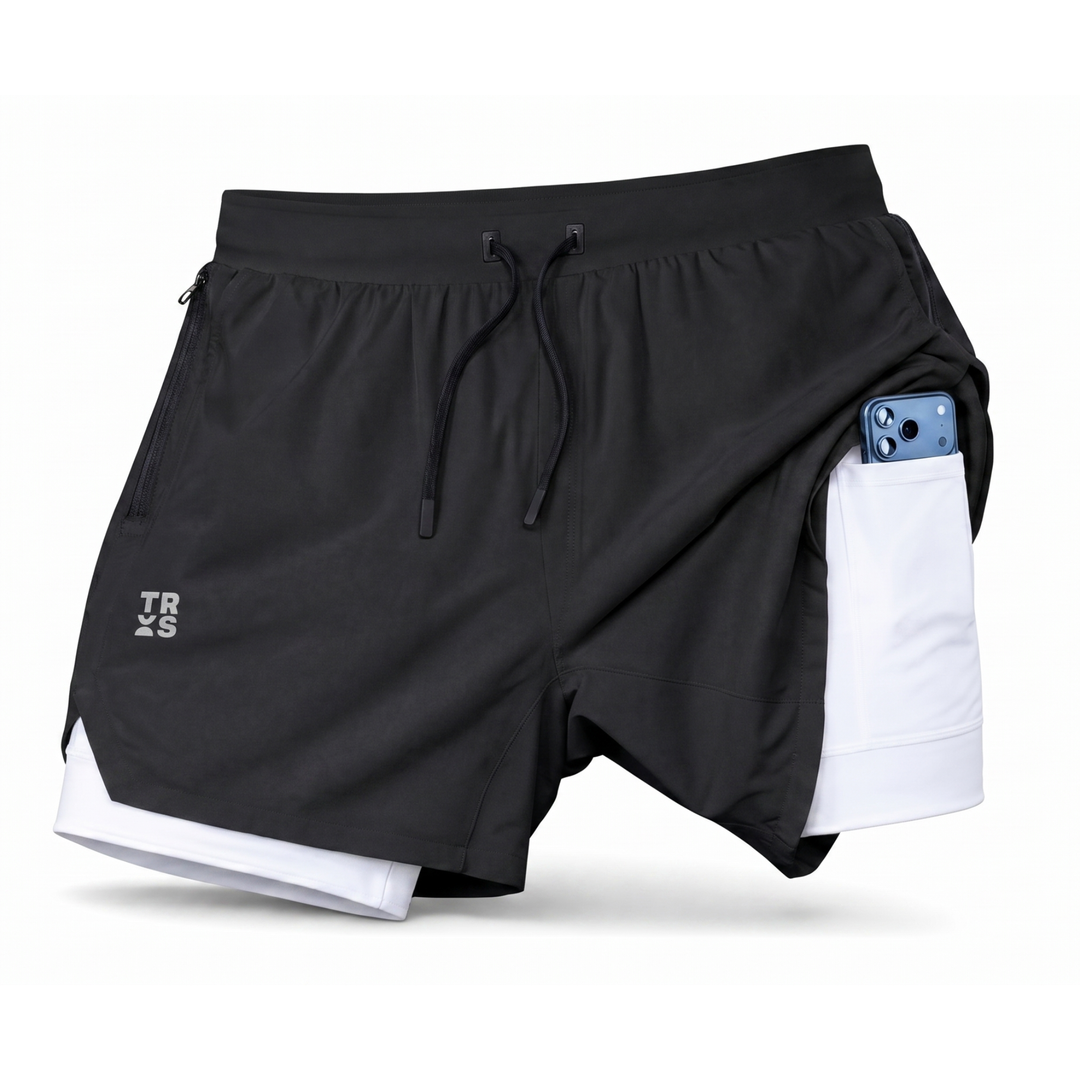 TROS Resilience PDP 2026-05 · Short Resilience - Negro Calza Blanca · 03 · 03 flat lay detail / phone / toallero