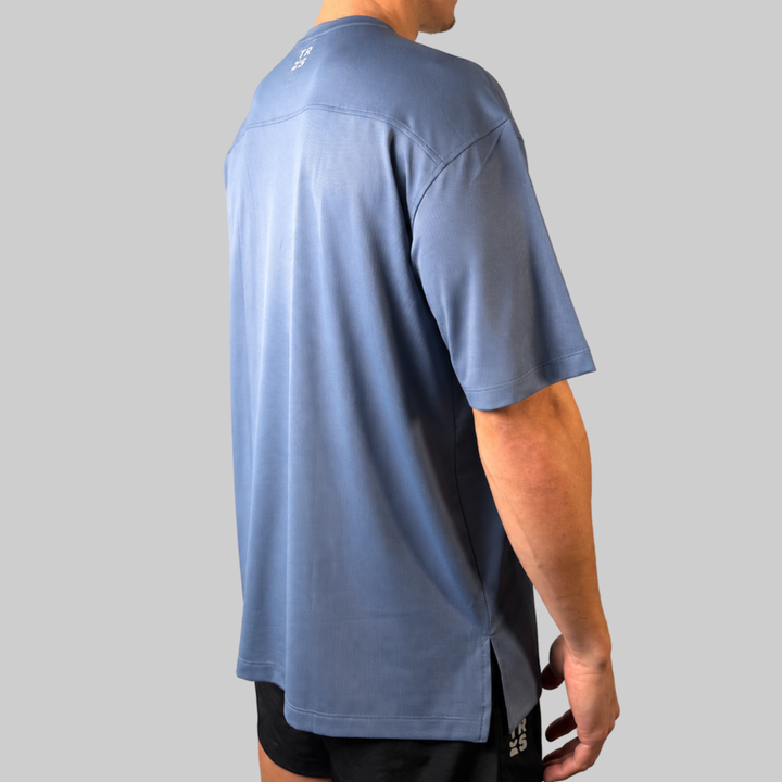 TROS Resilience PDP 2026-05 · Polera Resilience - Slate · 02 · 02 hover model worn/side-back
