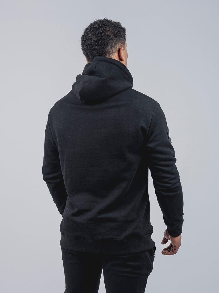 Rise Poleron Negro, Colección Rise, 100% Algodón, Poleron deportivo, Estilo de vida activo, Versatilidad, Negro, Bolsillo tipo canguro, Tela elástica, Amplitud, Calidez, Prenda de uso diario, Prenda para entrenar.